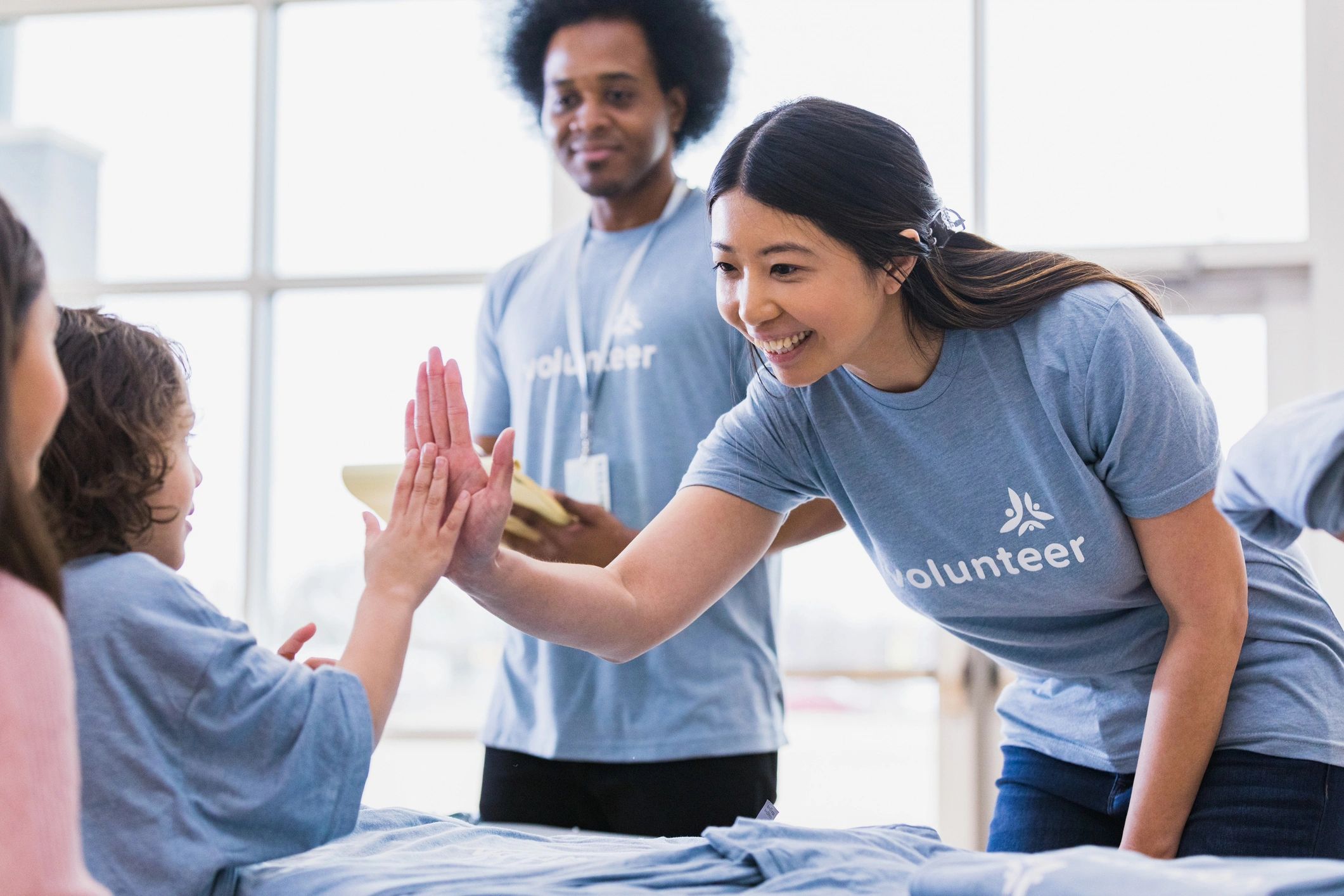 Volunteers greeting each other with a high five