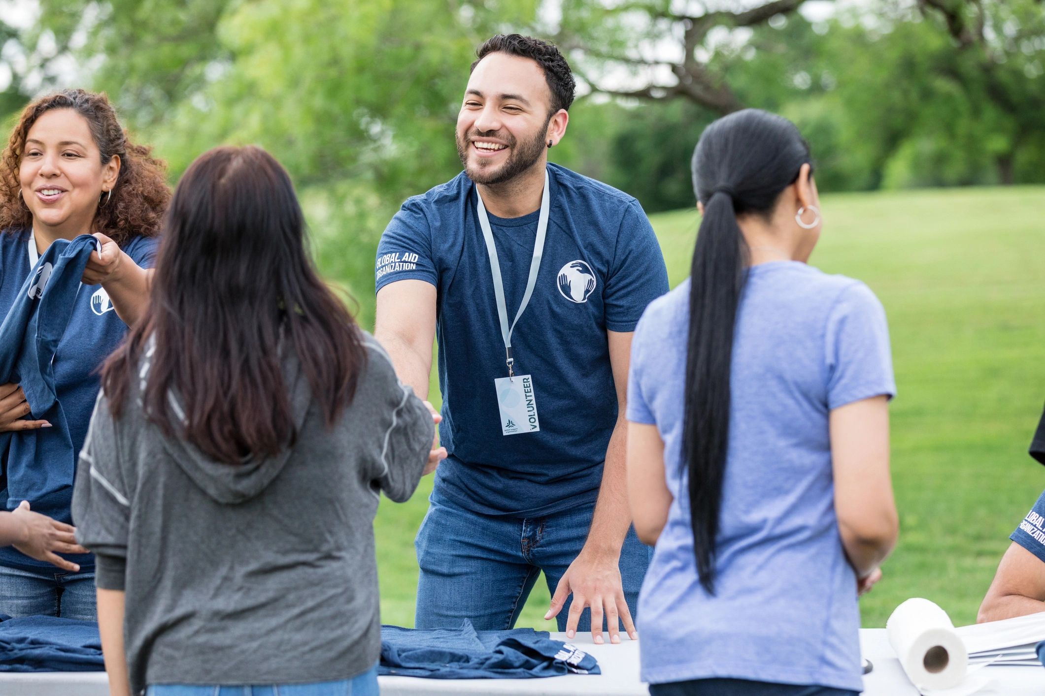 Volunteer greeting a community member at a park