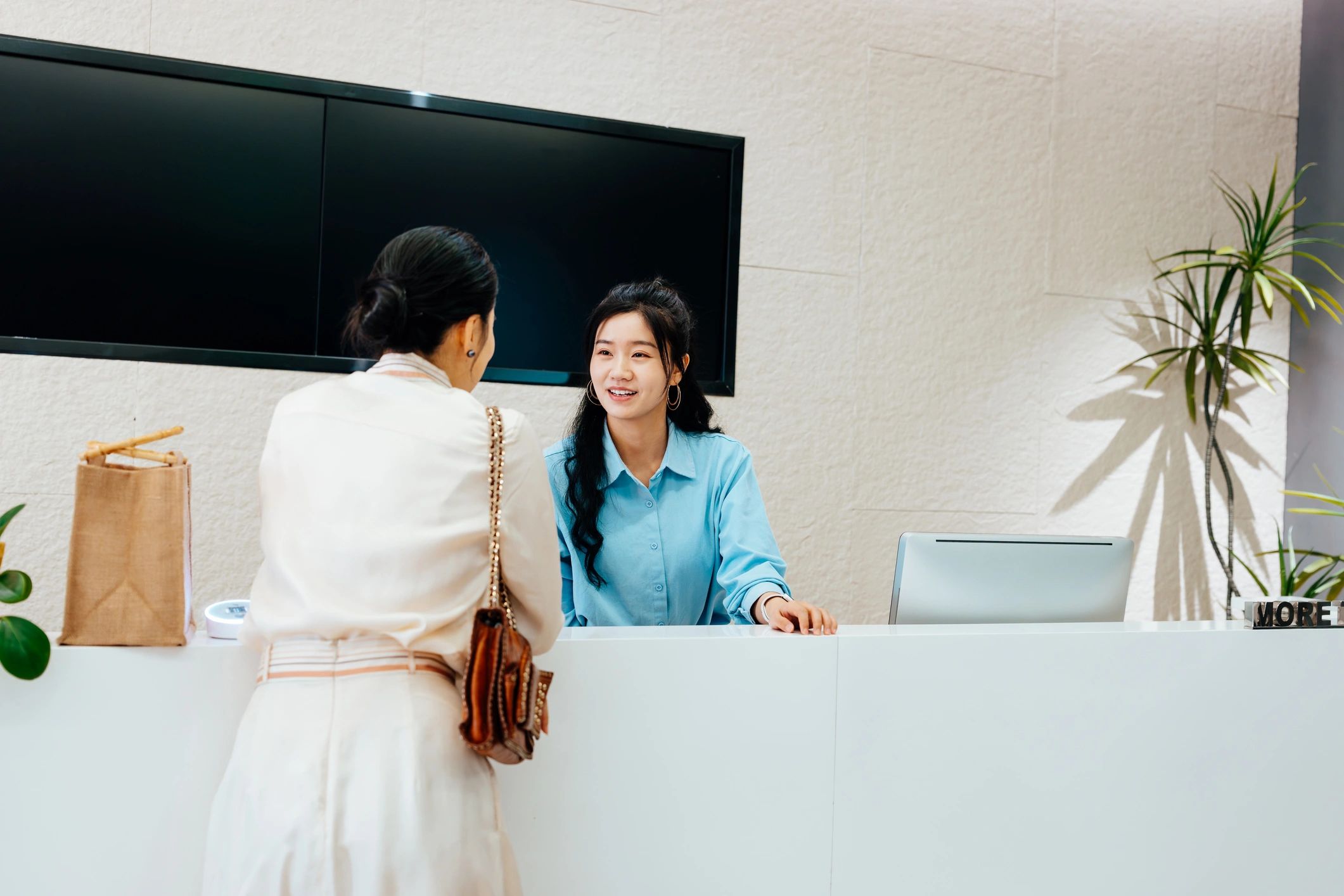 Staff members speaking together at a service counter