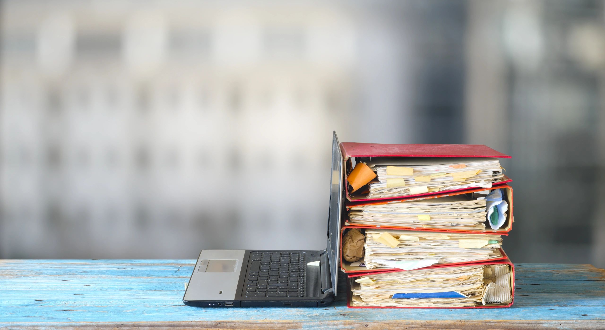 Office paperwork and binders representing records management